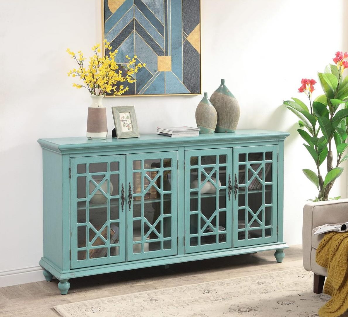 Beautiful geometric-shaped Chinese Chippendale fret work overlay allows a peek into the four doors of this credenza.