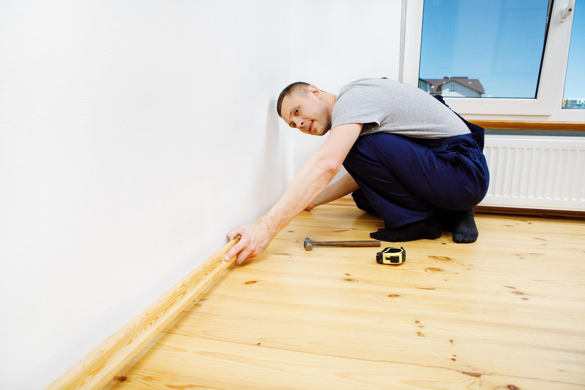 Man working with wood custom baseboard moulding