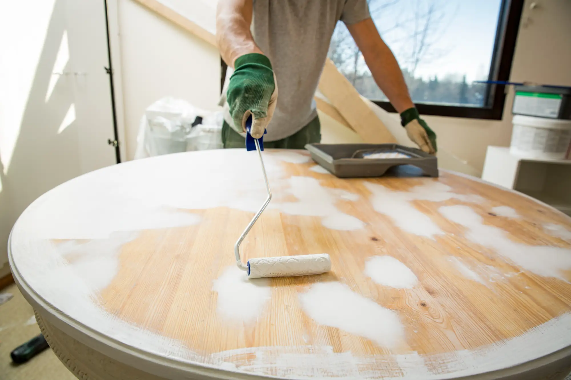 Man in Colorado Springs refinishing a dining room table